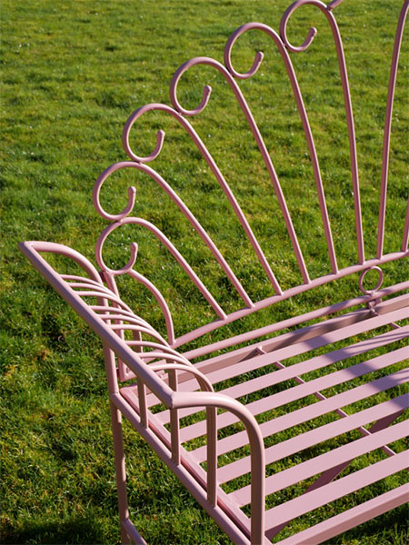 Pink Metal Garden Bench -Close up image showing the pink paint finish and the pattern on the pink metal garden bench